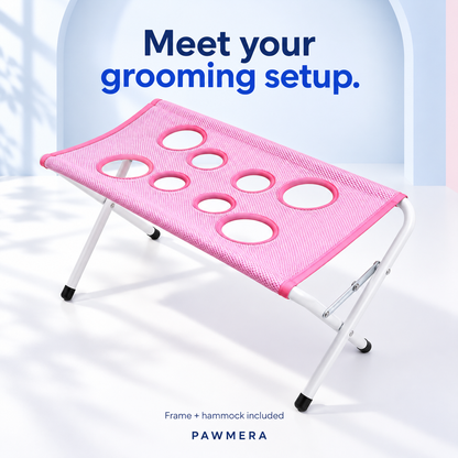 Pink Pawmera grooming stand with folding frame and mesh hammock — AI illustration